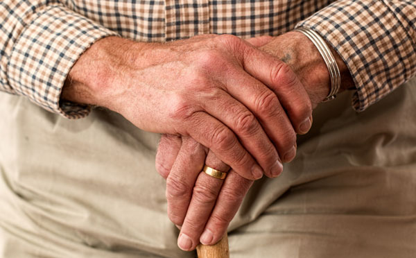 Man hands holding cane